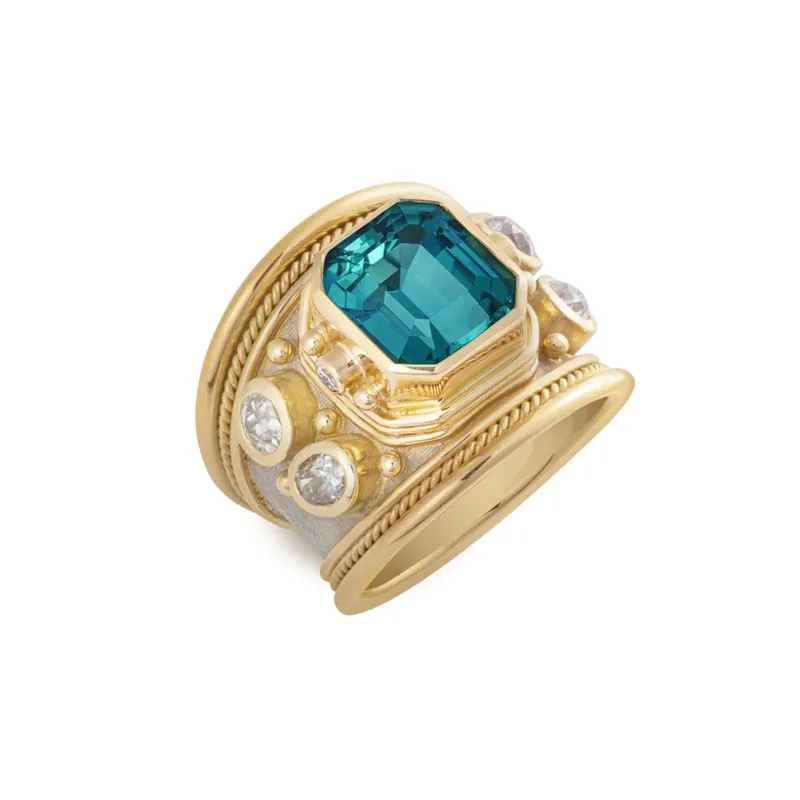 <p>Elizabeth Gage tapered Templar ring with a faceted octagon-shaped green-blue tourmaline of 5 carats, set alongside two brilliant-cut diamonds, four oval-shaped old-cut diamonds and decorated with gold bead details, crafted in 18k yellow and white gold</p>