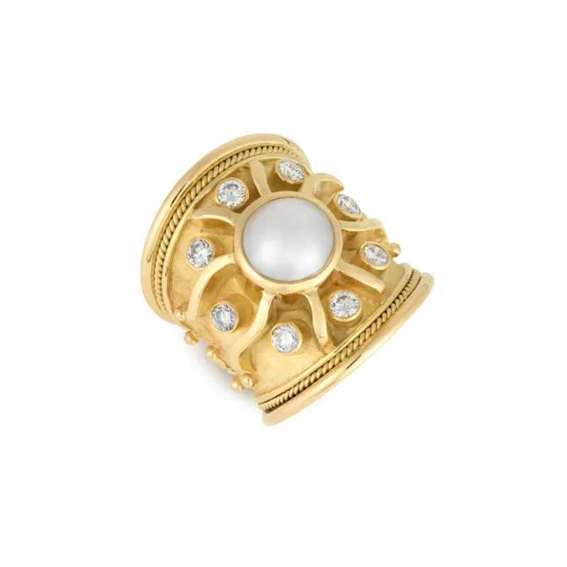 <p>Elizabeth Gage Sun ring with a sculpted flame motif, set with a round mabé pearl and brilliant-cut diamonds in 18k yellow gold</p>