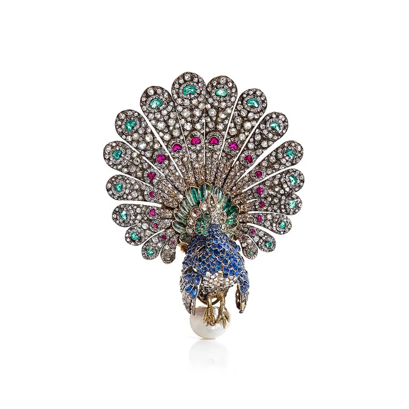 <p>‘Peacock’ brooch with sapphires, emeralds, rubies, diamonds and pearl in yellow gold circa 1865</p>