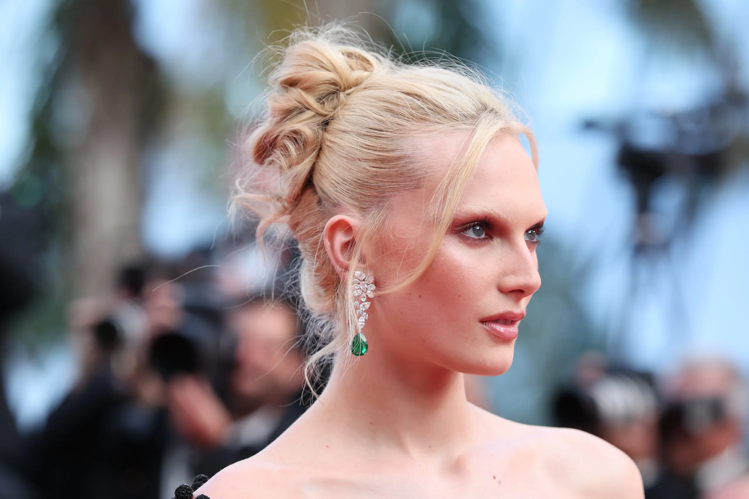<p>American model and Influencer Alex Consani wears pear-shaped emerald and diamond earrings by Chopard to the Cannes Film Festival 2025</p>

