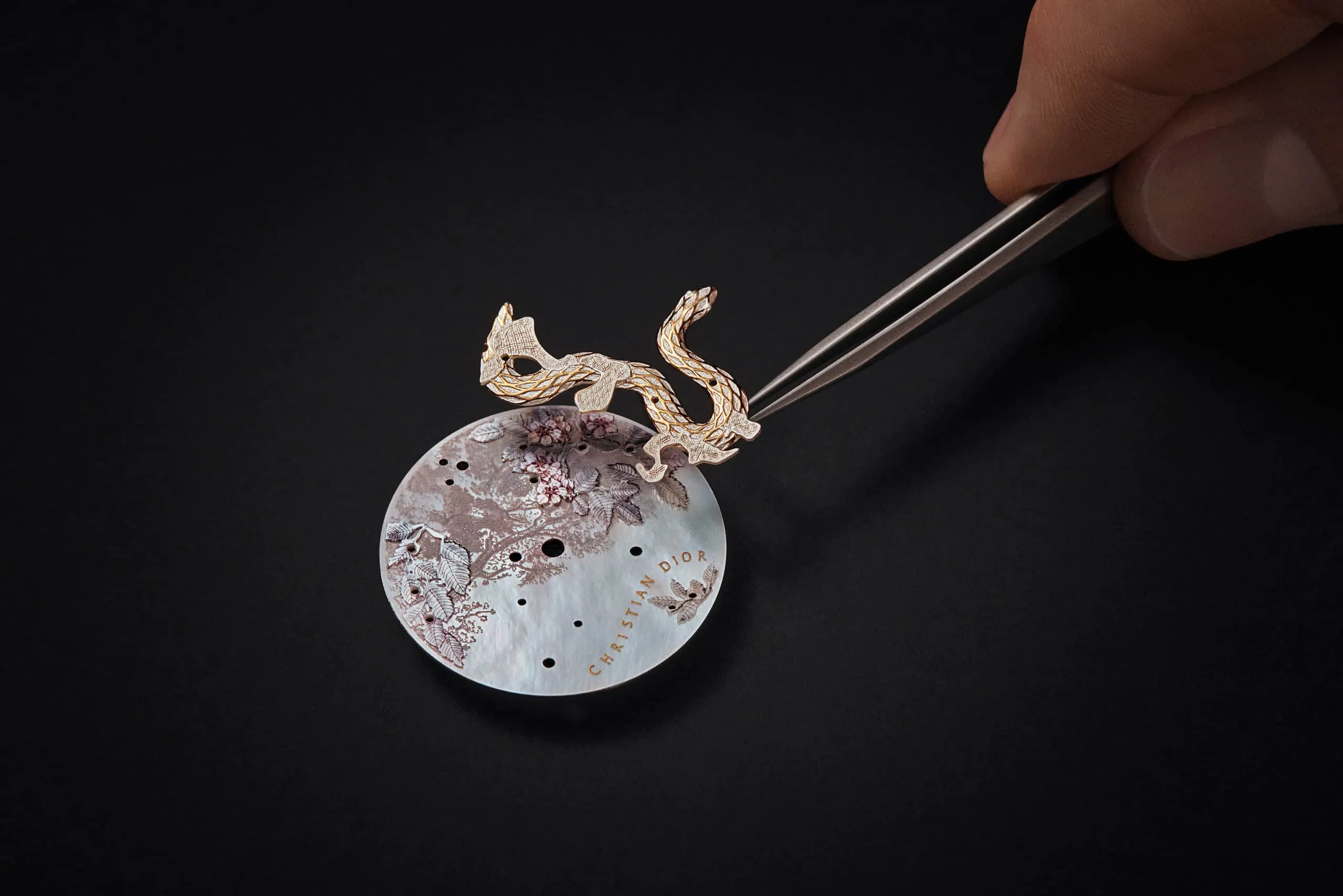 <p>A snake with rose gold scales features prominently on the dial of the Dior Grand Soir Year of the Snake watch</p>