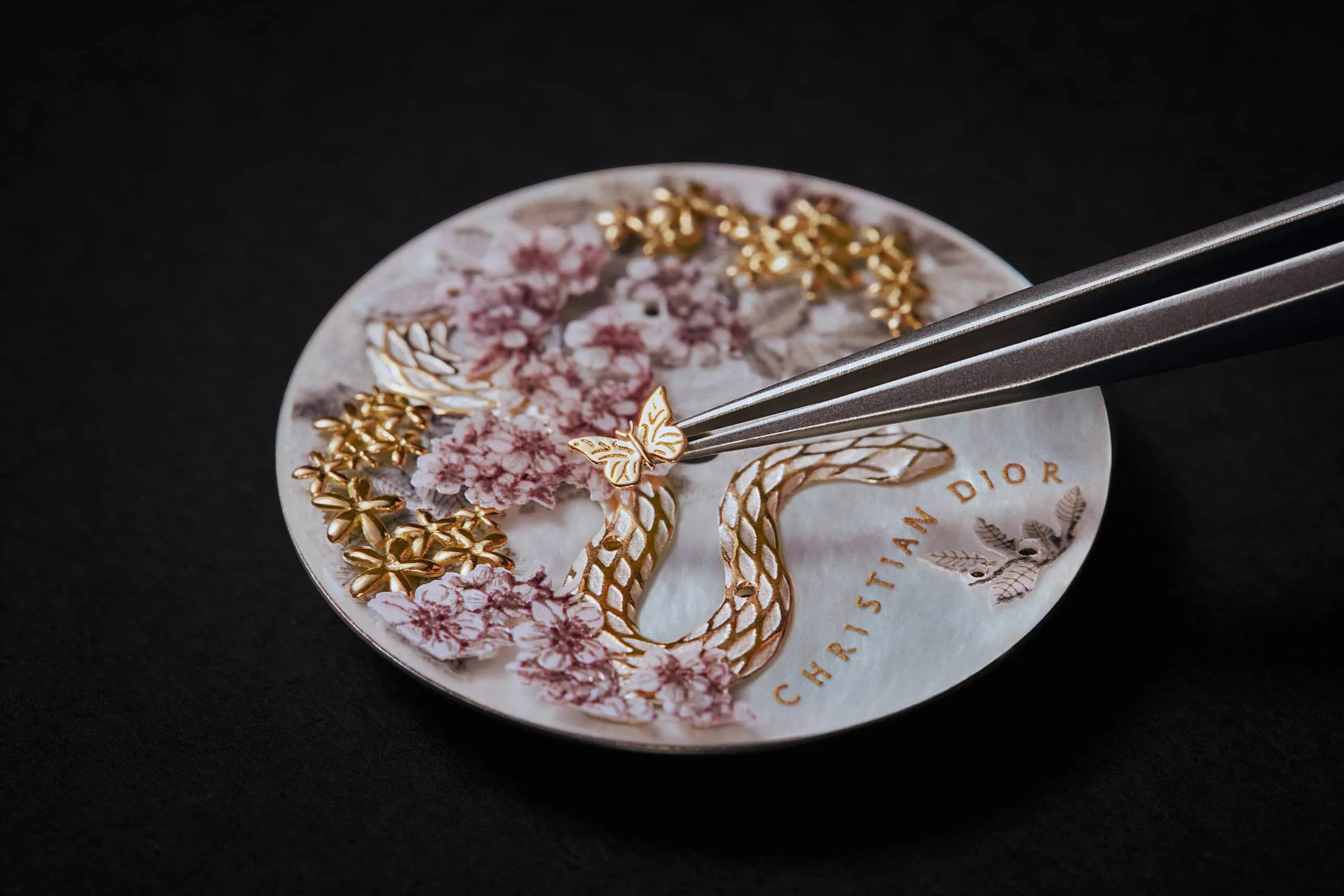 <p>Miniature details, including golden butterflies, adorn the decorative dial of the Dior Grand Soir Year of the Snake watch</p>