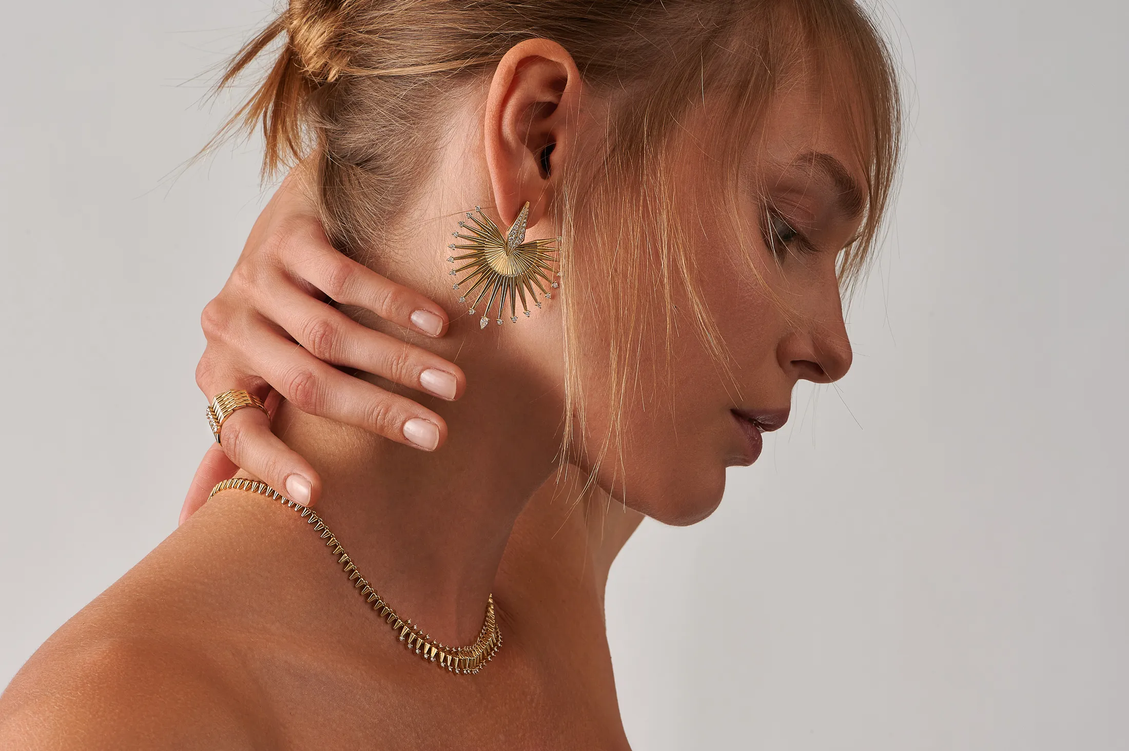 <p>A model wears pieces from the Ariadne collection by Dionysios Fine Jewels set with natural diamonds in 18k yellow gold</p>
