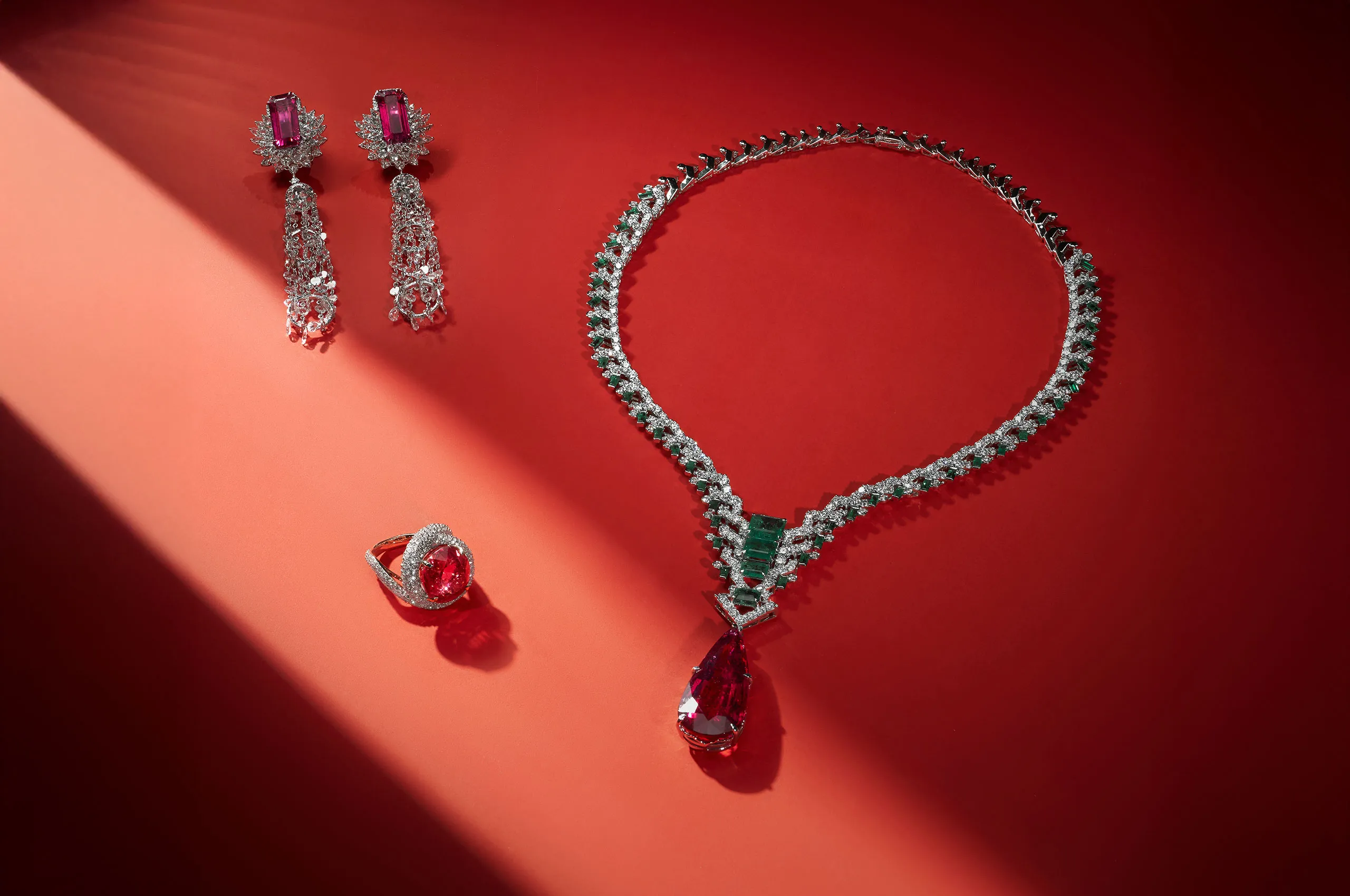 <p>Jaipur Gems Phoenix Heart necklace with a 37-carat pear-shaped rubellite from Madagascar surrounded by diamonds and emeralds, shown here with the Rose of the Desert ring with a 15-carat rubellite and the Stardust Symphony earrings with 14 carats of rubellites and rose-cut diamonds  </p>
