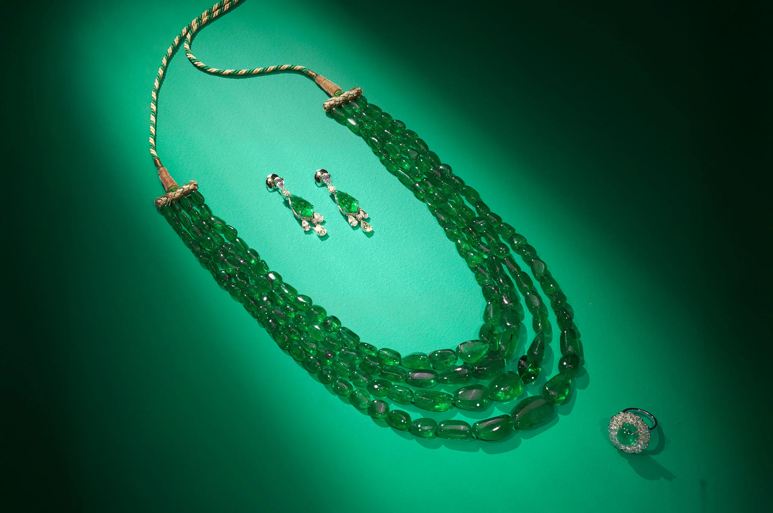<p>Jaipur Gems Serene Sanctuary necklace with over 860 carats of Colombian emeralds, shown here alongside the Starlit Gleam earrings with 16 carats of emeralds and the Halo’s Embrace ring with a 9-carat emerald and diamonds </p>
