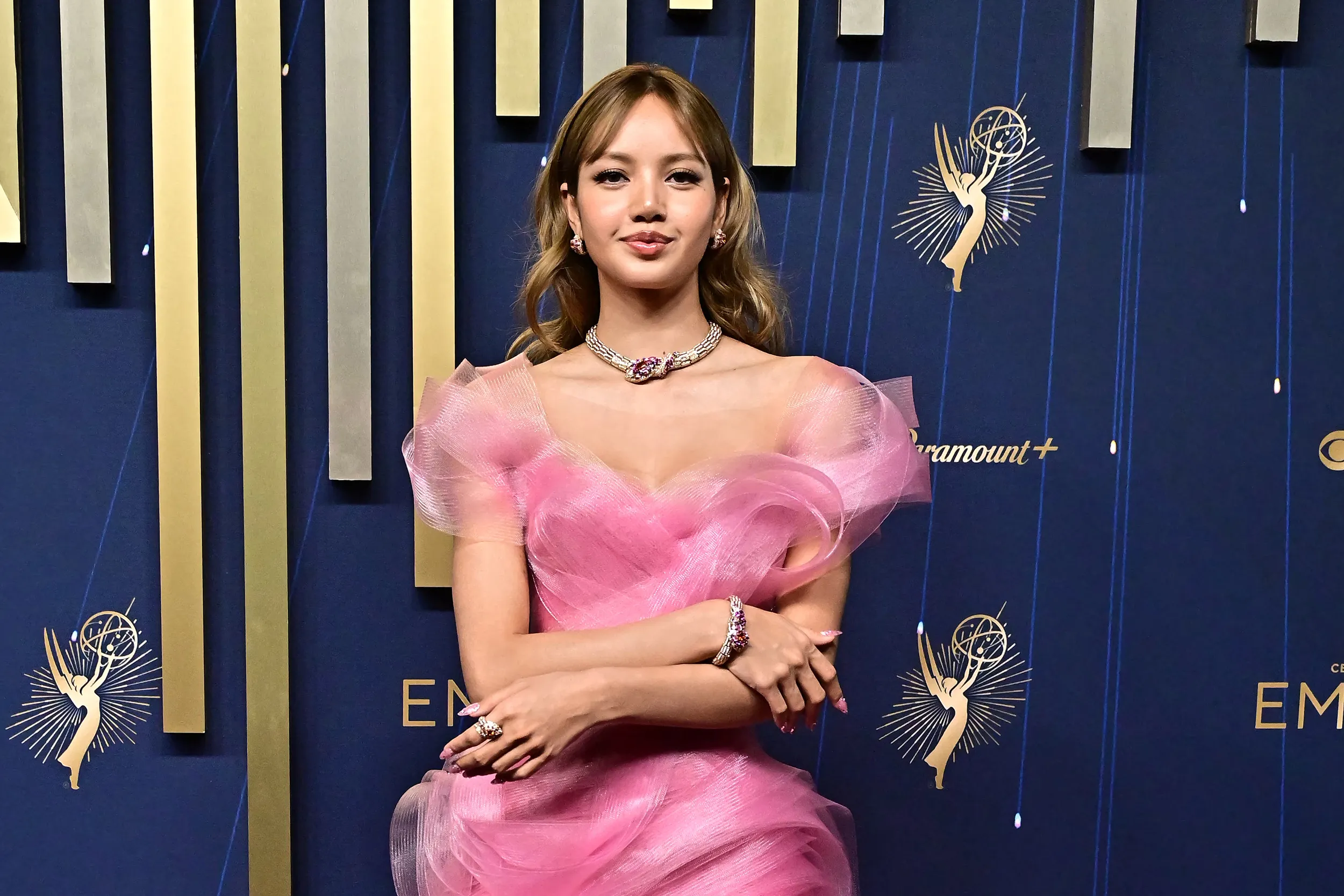 <p>Lisa Manobal of Blackpink at the 2025 Emmy Awards wearing a suite of Bvlgari Serpenti High Jewellery, including a necklace, bracelet, earrings and ring with oval-shaped garnets, marquise-shaped fancy sapphires, orange garnets, and diamonds, set in 18k yellow gold</p>

