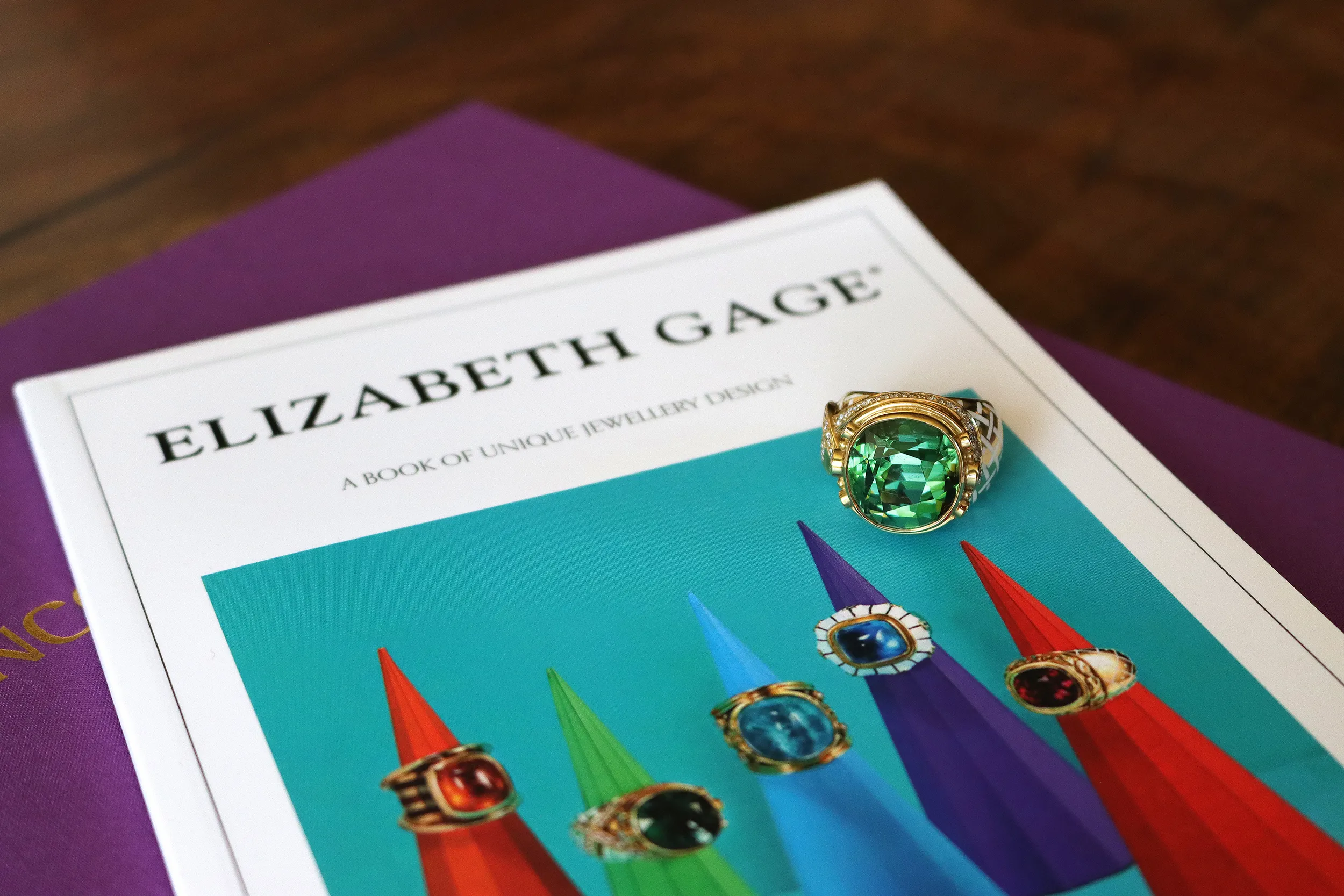 <p>Elizabeth Gage ring with an 18.52 carat faceted cushion-shaped green tourmaline, 38 pavé-set diamonds in an asymmetric collar design, further round brilliant-cut diamonds and white enamel in a trellis pattern, crafted in 18k yellow gold</p>