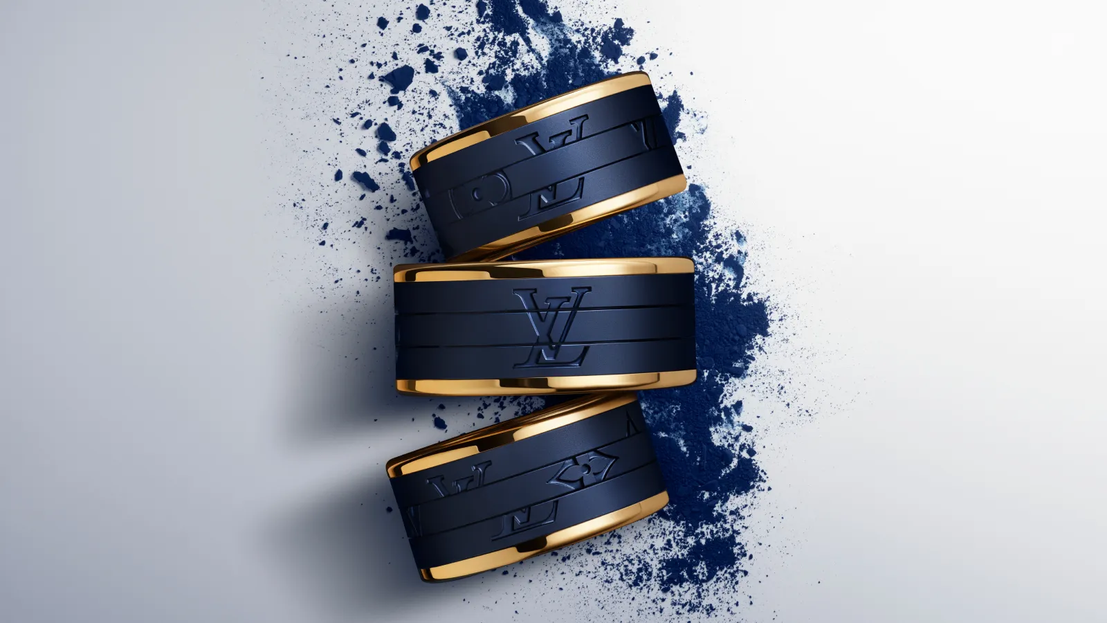 <p>A trio of Les Gastons Vuitton men’s rings by Louis Vuitton in blue titanium and 18ct yellow gold</p>