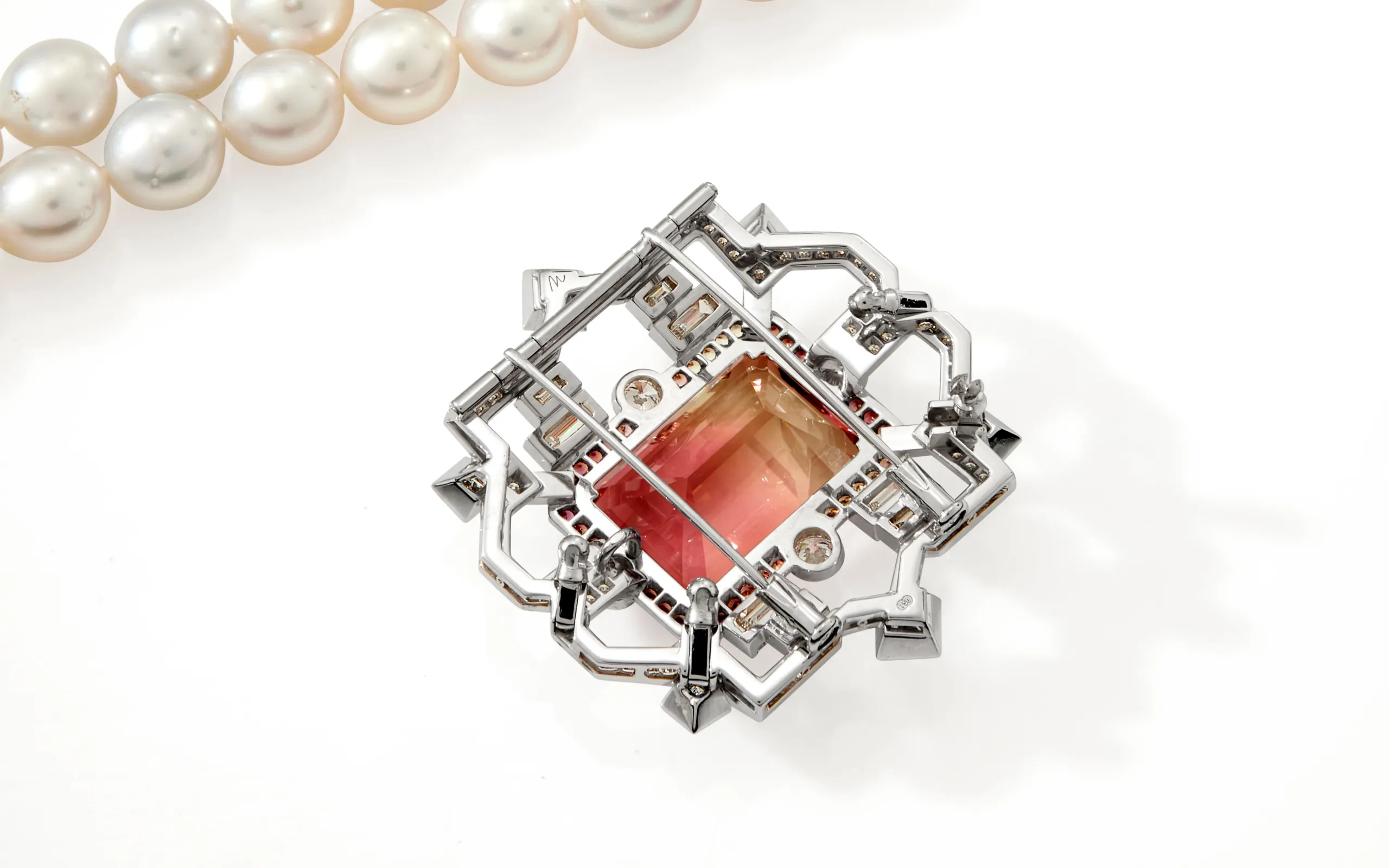 <p>The reverse side of an Art Deco-inspired brooch-pendant by Matthew Ely, set with a 24.34 carat bi-colour tourmaline, sapphires and diamonds in 18k white gold </p>