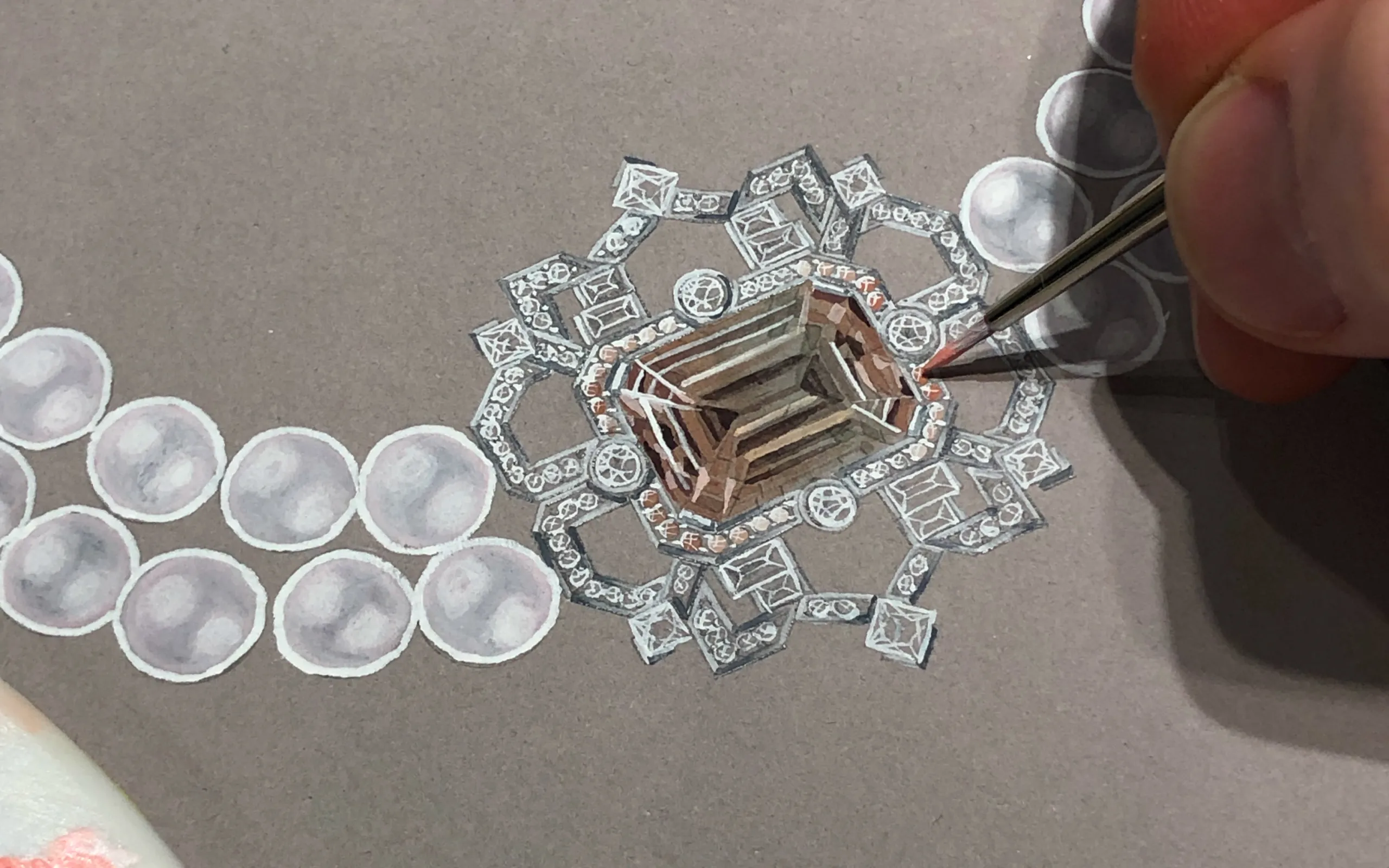 <p>Designing the Art Deco-inspired transformable brooch-pendant by Matthew Ely, set with a 24.34 carat bi-colour tourmaline in shades of pink, surrounded by colour fade sapphires and diamonds in 18k white gold </p>