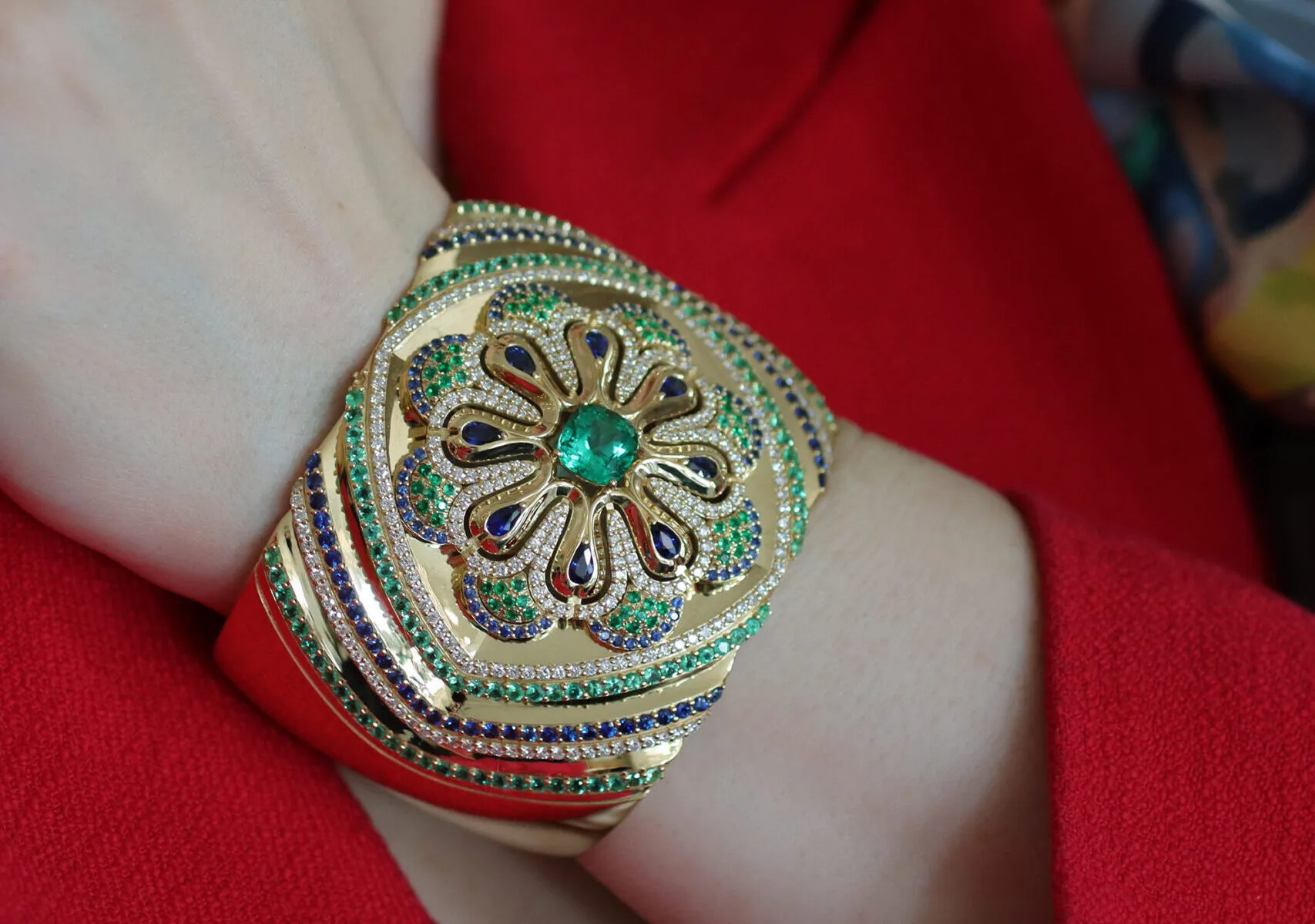 <p>The Miseno Arco High Jewellery cuff bangle features a mosaic-inspired pattern of diamonds, blue sapphires and Colombian emeralds, set in 18k yellow gold</p>
