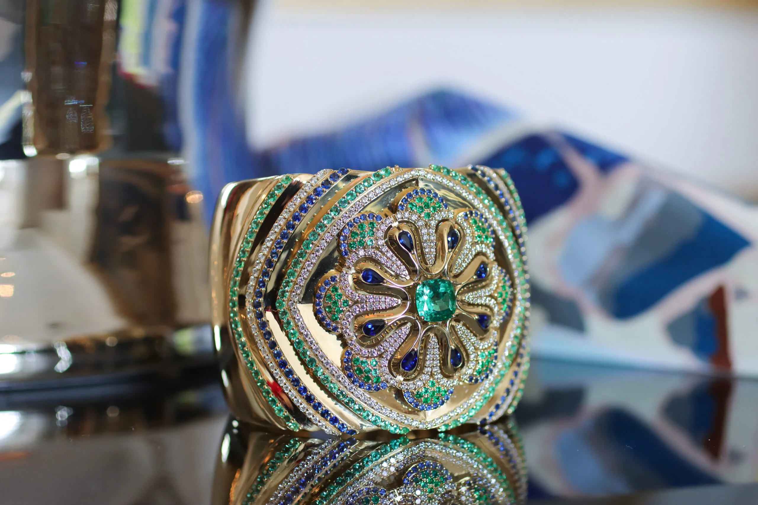<p>Miseno Arco High Jewellery cuff bangle with diamonds, blue sapphires and Colombian emeralds set in 18k yellow gold</p>
