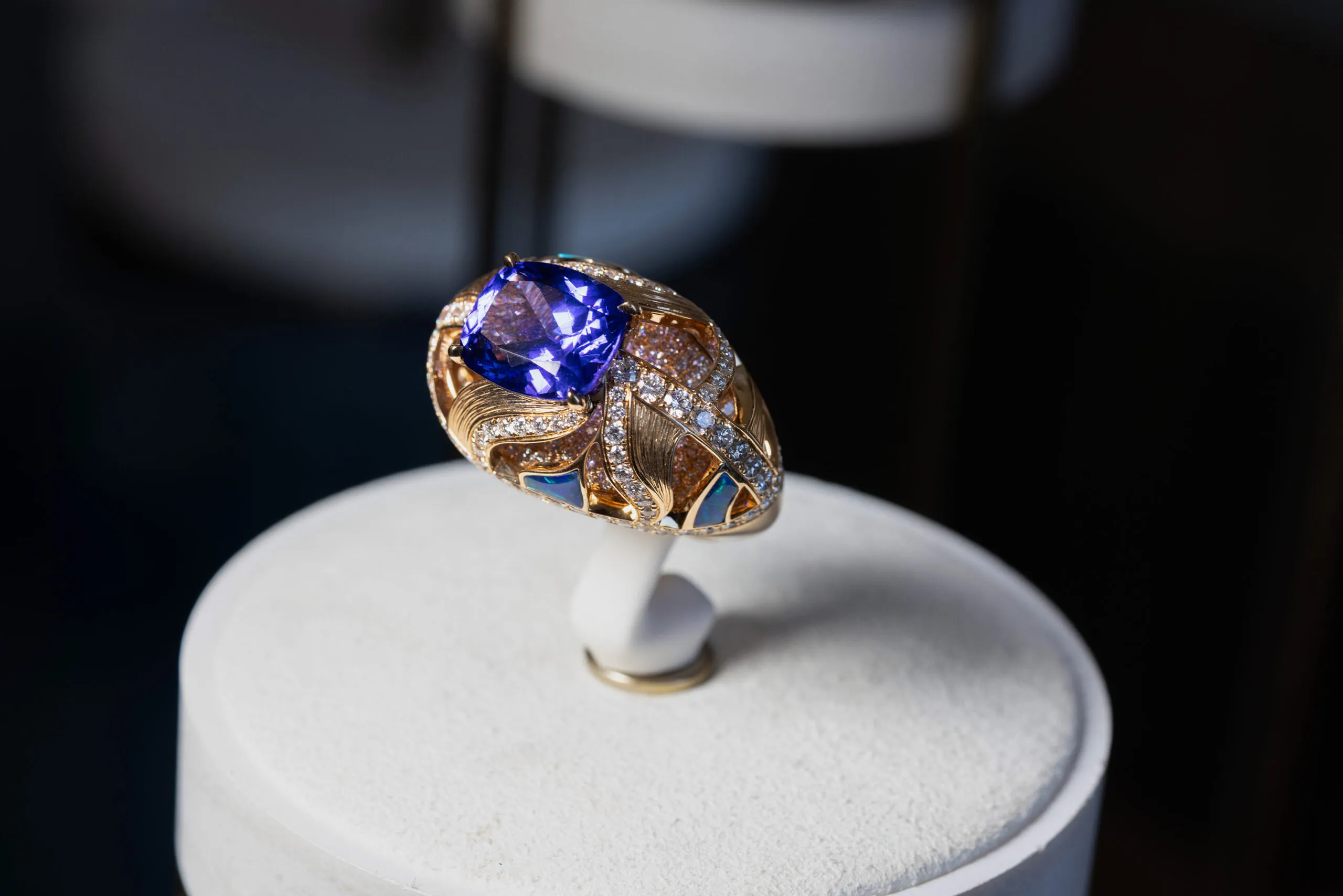 <p>A ring completes the suite, set with a cushion cut sapphire centre stone</p>
