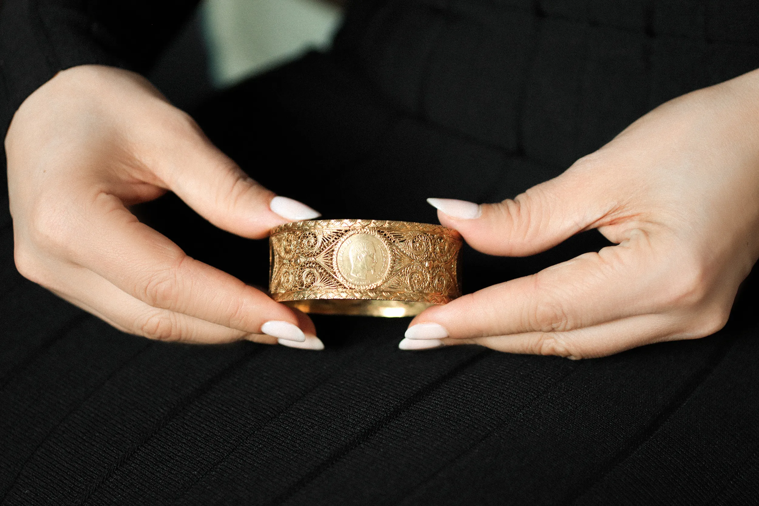 <p>A closer look at the intricate golden filigree and historic coin at the heart of a yellow gold bangle in the personal collection of Her Royal Highness Princess Yasmine Murat, Princess of Pontecorvo</p>