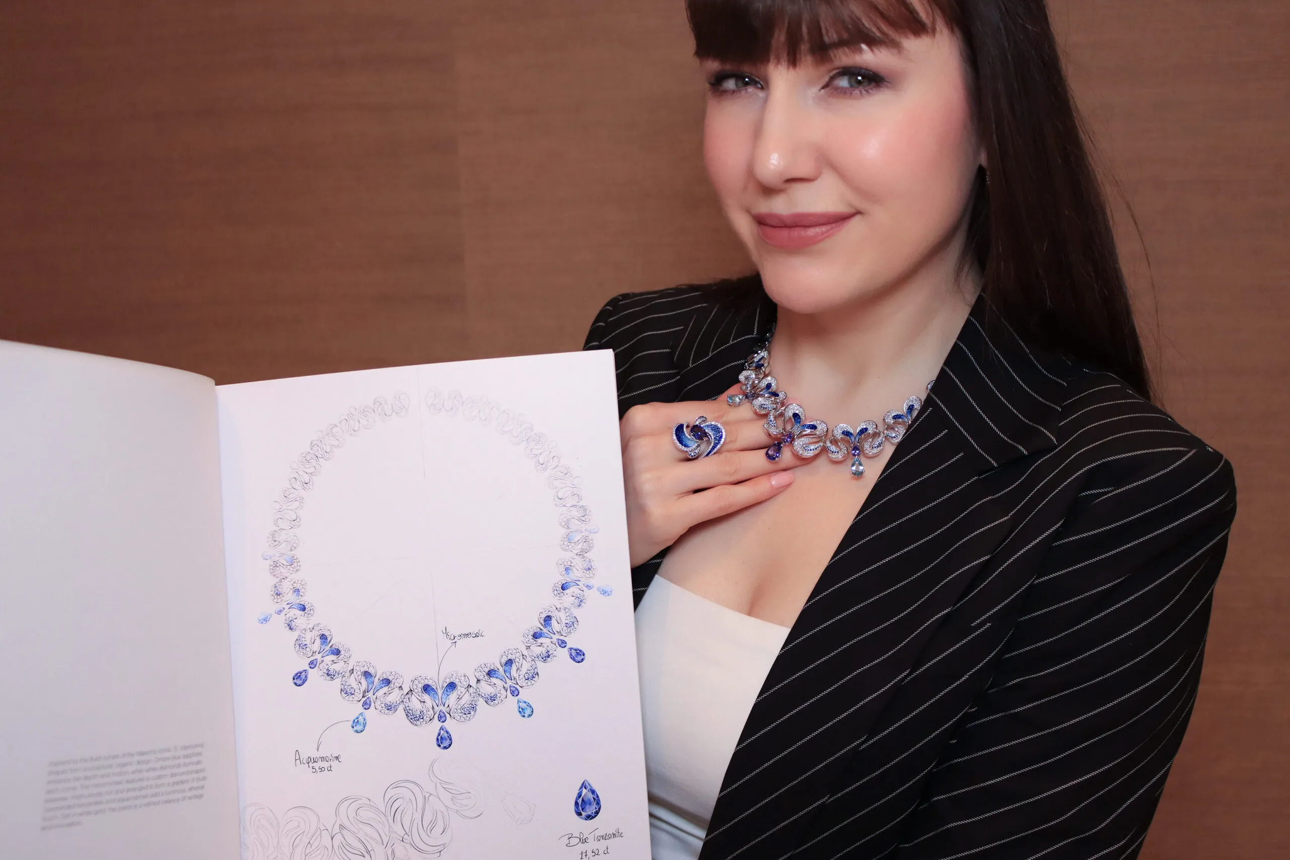 <p>Katerina Perez wears the SICIS Icon necklace and matching ring featuring a sculptural interpretation of the letter &#8216;S&#8217; with pear-shaped tanzanites and aquamarines, blue sapphires and micromosaics in white gold </p>
