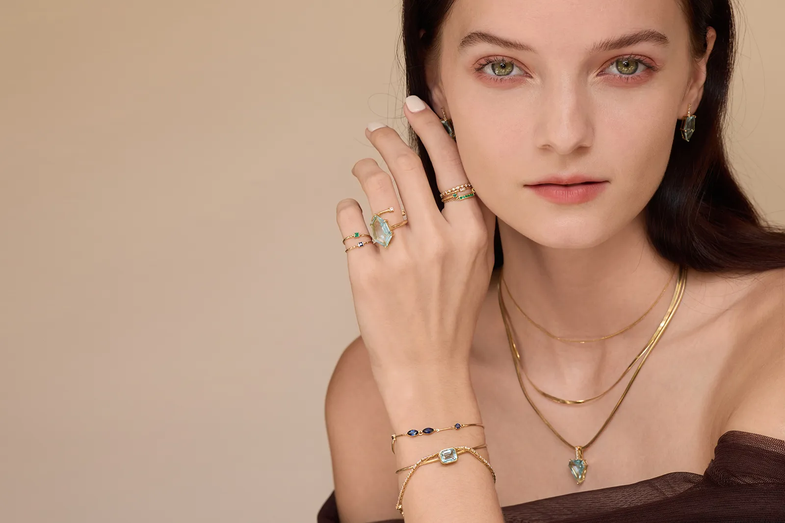 <p>A model wears a selection of pieces by Yi Collection, including aquamarines from the new Contour collection </p>