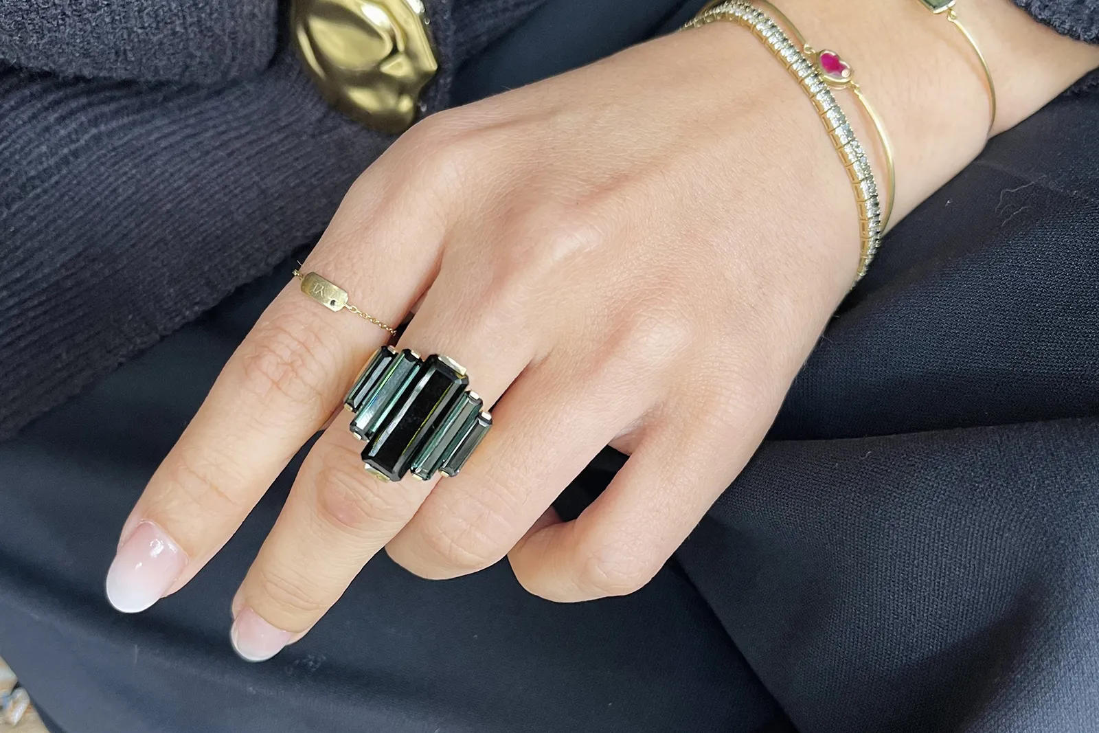 <p>Yi Collection Tourmaline Rhythm Supreme ring with a central black tourmaline surrounded by two pairs of blue tourmalines, totalling 12.725 carats, set in 18k yellow gold </p>
