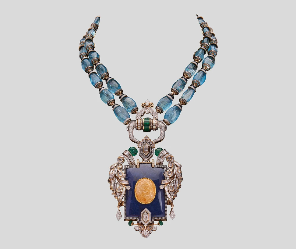 <p>Chhaya Jain necklace from the Art Deco Muse collection with 18.48 carats of diamonds, 163.29 carats of aquamarine, 29.80 carats of Zambian emeralds and 147.47 carats of lapis lazuli fused with a carved yellow sapphire, set in 18k white gold </p>