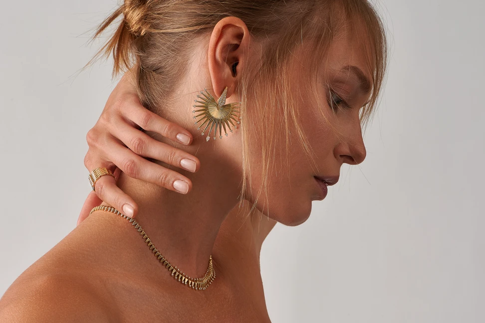 <p>A model wears pieces from the Ariadne collection by Dionysios Fine Jewels set with natural diamonds in 18k yellow gold </p>
