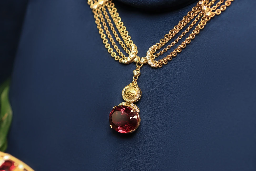 <p>The Azza Fahmy Chains of Happiness necklace from the second chapter of the Tales of the Nile High Jewellery collection with a 26.18-carat oval-cut rubellite, framed by round brilliant-cut diamond crescents and calligraphy that translates to ‘happiness’</p>