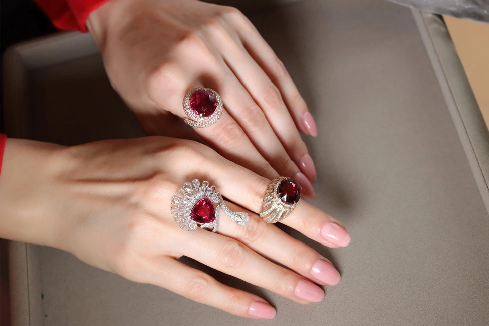 <p>Katerina Perez wears a trio of Jaipur Gems rings including (from top to bottom) the Twilight Embrace ring, the Majestic Blush ring and the Scarlet Bloom ring set with rubellites, pink tourmalines and diamonds</p>
