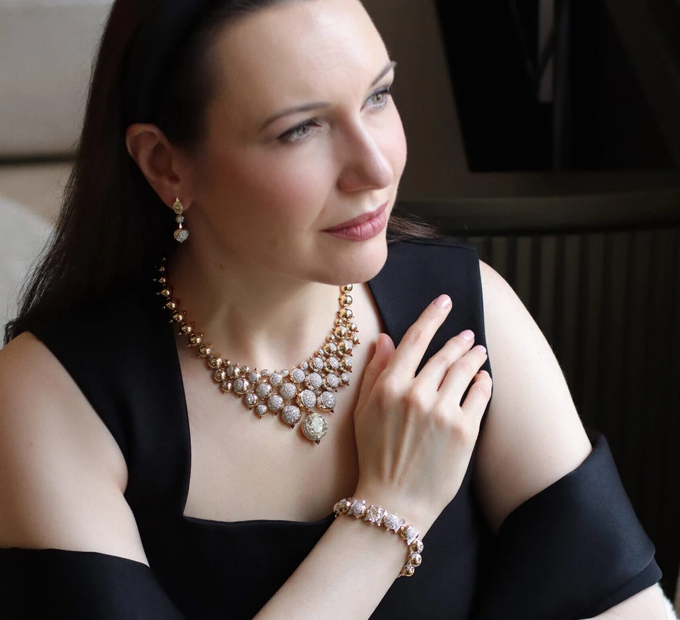 <p>Katerina Perez wears the Sahag Arslanian Lunar Eclipse Grand Collier with a 15.59-carat oval-shaped fancy yellow diamond and 18.32 carats of round brilliant-cut white diamonds, set in 18k white and yellow gold, alongside the matching earrings and a bracelet </p>
