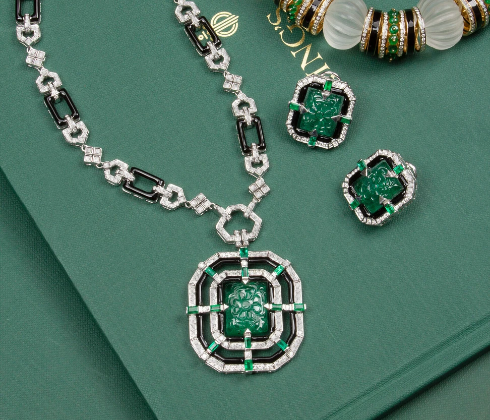 <p>Nafees Jaipur Art Deco-inspired set featuring a pendant necklace with a 17.18 carat carved Zambian emerald and matching 24.24 carat emerald stud earrings, both set in 18k white gold with polished onyx and diamond</p>
