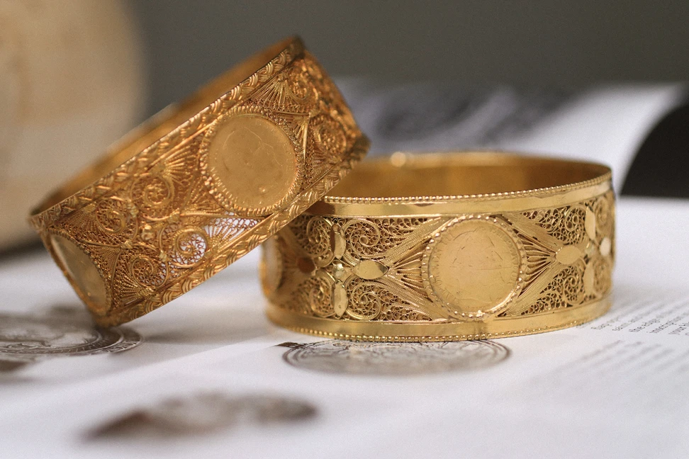 <p>A pair of filigree yellow gold bangles, owned by Princess Yasmine, passed down from her mother and grandmother and crafted from the gold coins of Napoleon III</p>