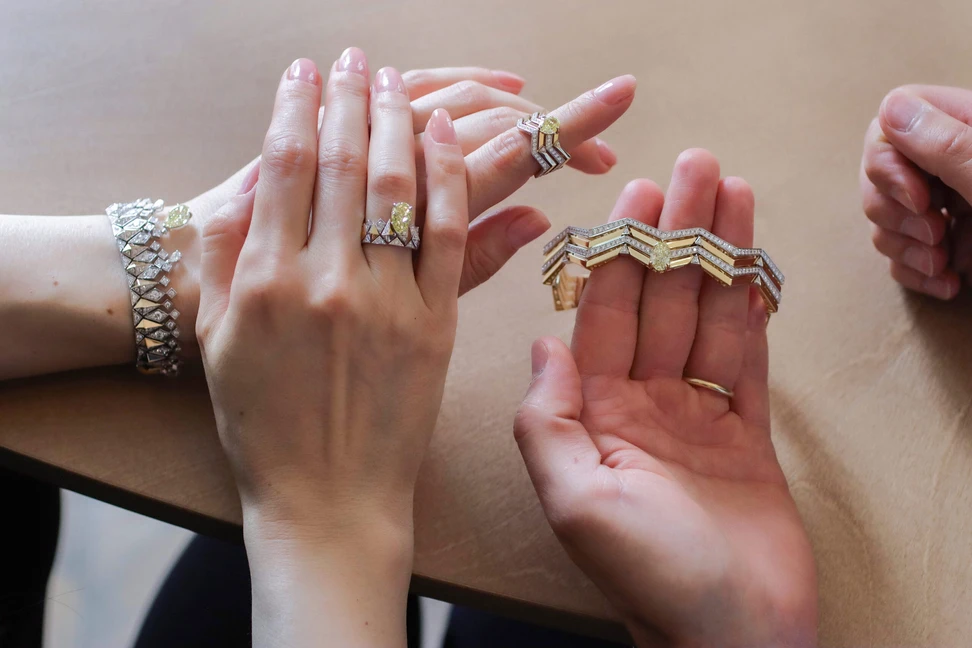 <p>Katerina Perez and Sahag Arslanian browse pieces from his debut high jewellery collections, including (from left to right) the Sun Rays ring with a 2.38-carat pear-shaped fancy intense yellow VS2 diamond, the Sun Rays bracelet with a 3.11-carat pear-shaped fancy yellow VS2 diamond drop, the Celestial Radiance ring with a 2.44-carat cushion-cut fancy dark brown yellow VS1 diamond, and the Celestial Radiance bracelet with a 2.31-carat oval-shaped fancy yellow SI1 diamond</p>
