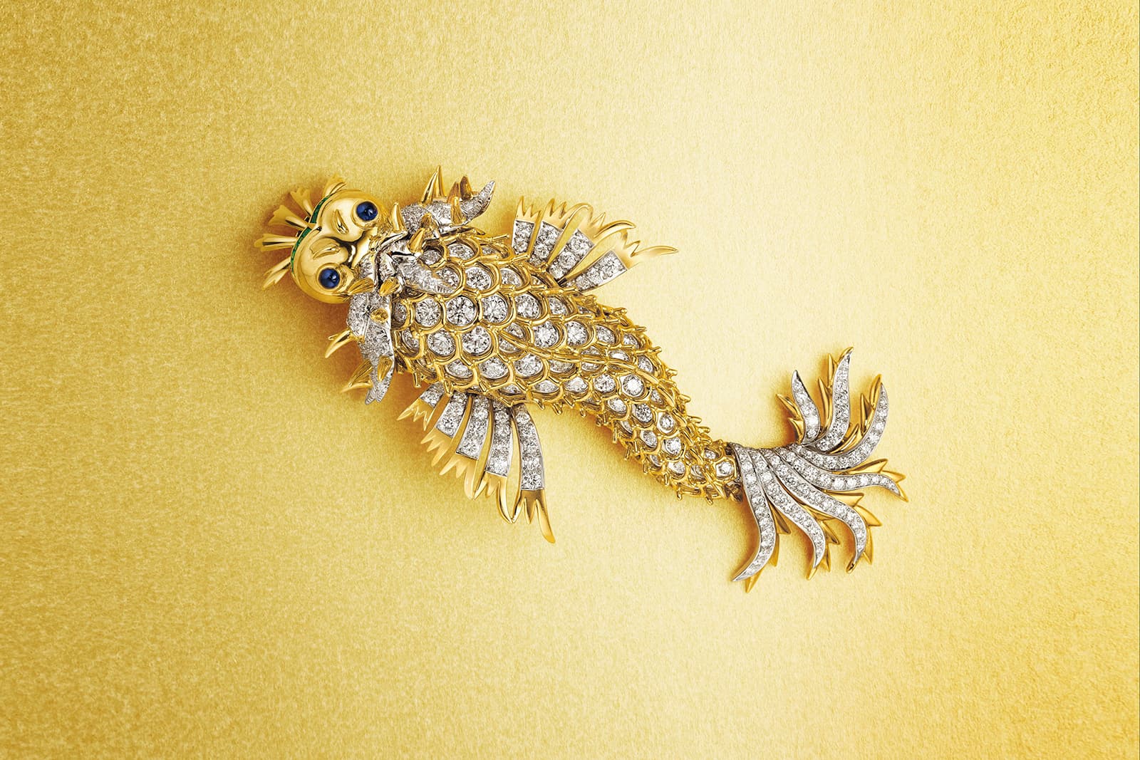 A charming ‘Dolphin’ brooch with diamonds, sapphires and emeralds by Jean Schlumberger