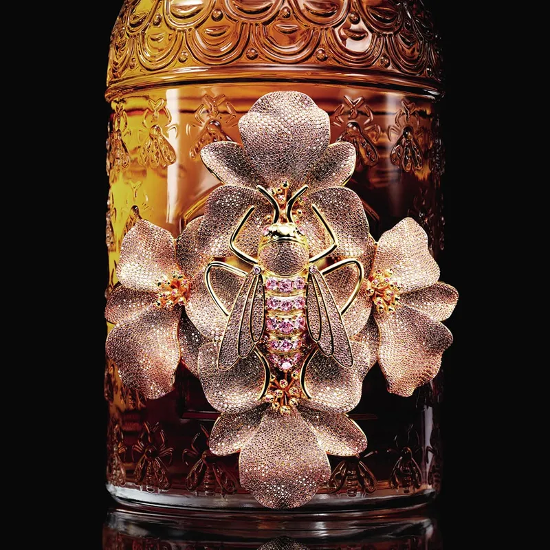 <p>A bee in gilded bronze sits atop four orchids, inlaid with 6,5000 stones</p>