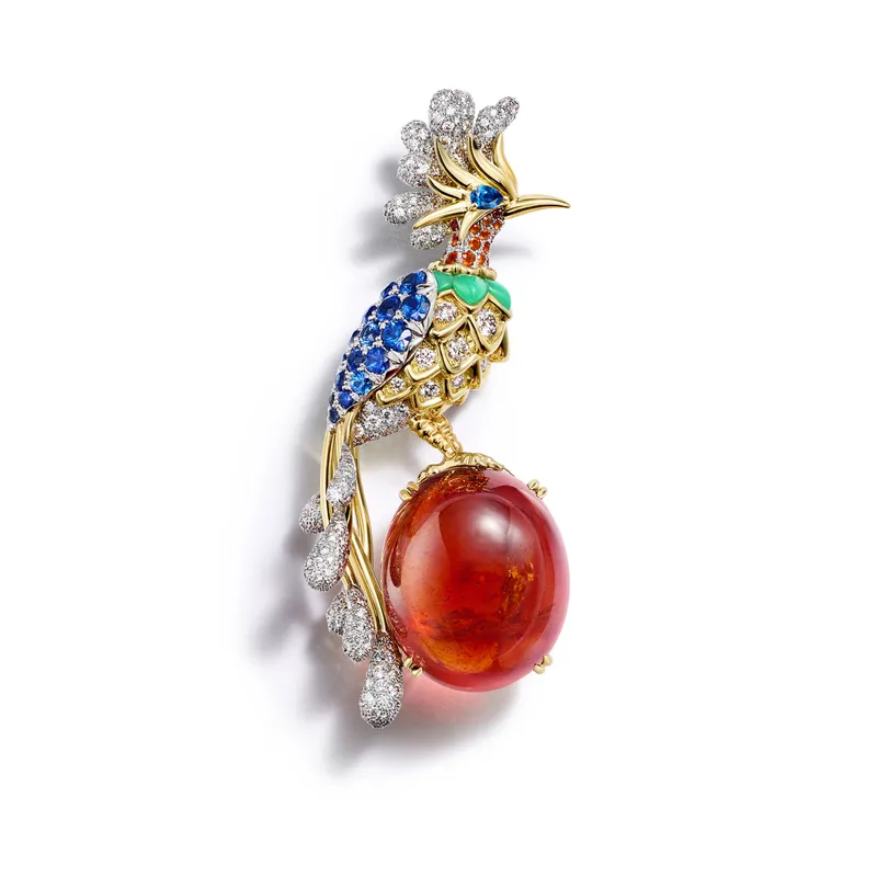 <p>Tiffany &amp; Co. Blue Book Hidden Garden Bird on a Rock Paradise Bird brooch in platinum and 18k yellow gold with a 66.60ct oval cabochon spessartine, sapphires, a fire opal, chrysoprase and diamonds</p>
