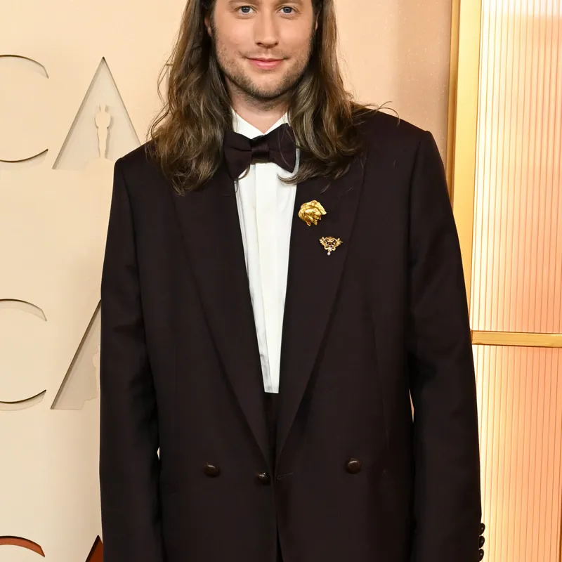 <p>Ludwig Göransson wears Boucheron Assyrian Lion brooch from 1920 in yellow gold, set with ruby and diamonds, Lion’s Head brooch from 1901, Quatre Radiant Edition wedding band in pink gold, set with brown PVD, Quatre Clou de Paris wedding band in yellow gold and Quatre Classique XS ring in white gold, yellow gold and pink gold, set with diamonds and brown PVD</p>
