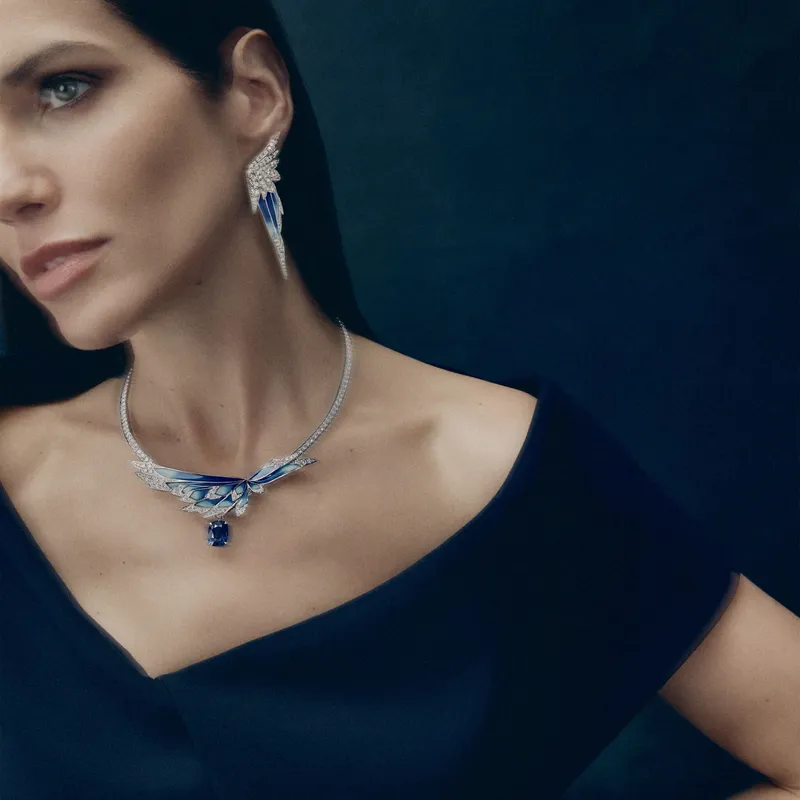 <p>A model wears the Envol high jewellery grand feu enamel and diamond necklace and earrings in 18ct white gold. Both are transformable</p>
