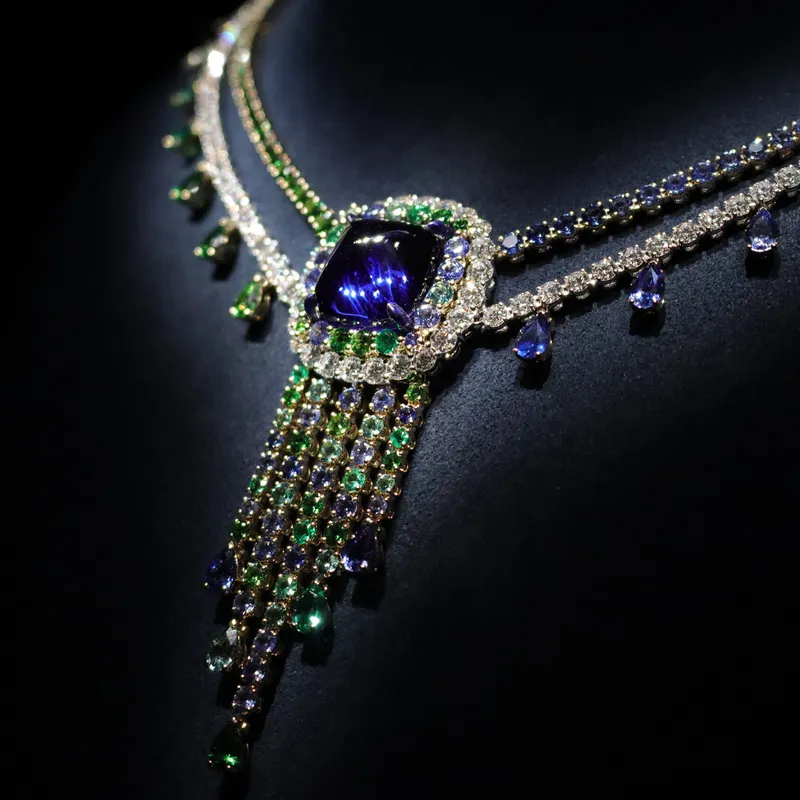 <p>A striking sugarloaf tanzanite necklace in the Belle Dior High Jewellery collection by Dior Joaillerie, featuring a fringe of green and blue gemstones</p>
