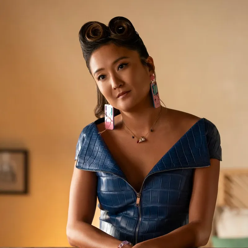 <p>Ashley Park, aka, Mindy Chen, in season 5 wearing a fun pair of Gameboy costume earrings</p>
