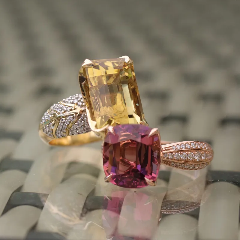 <p>An 18k yellow gold ring set with an 8.30 carat heliodore and 96 G/VS1 diamonds totalling 0.41 carats, and an 18k rose gold ring set with a 6.37 carat tourmaline and 54 G/VS1 diamonds totalling 0.39 carats </p>