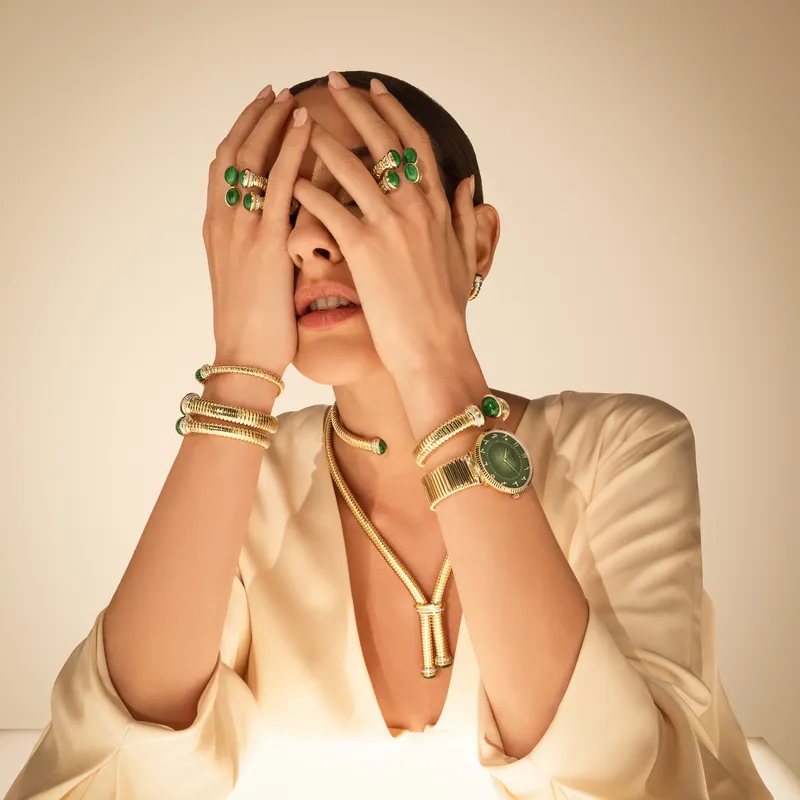<p>A model wears pieces from the new Tourbillon collection, including a pair of necklaces, bracelets and rings, alongside a HIMO Jewellery watch</p>