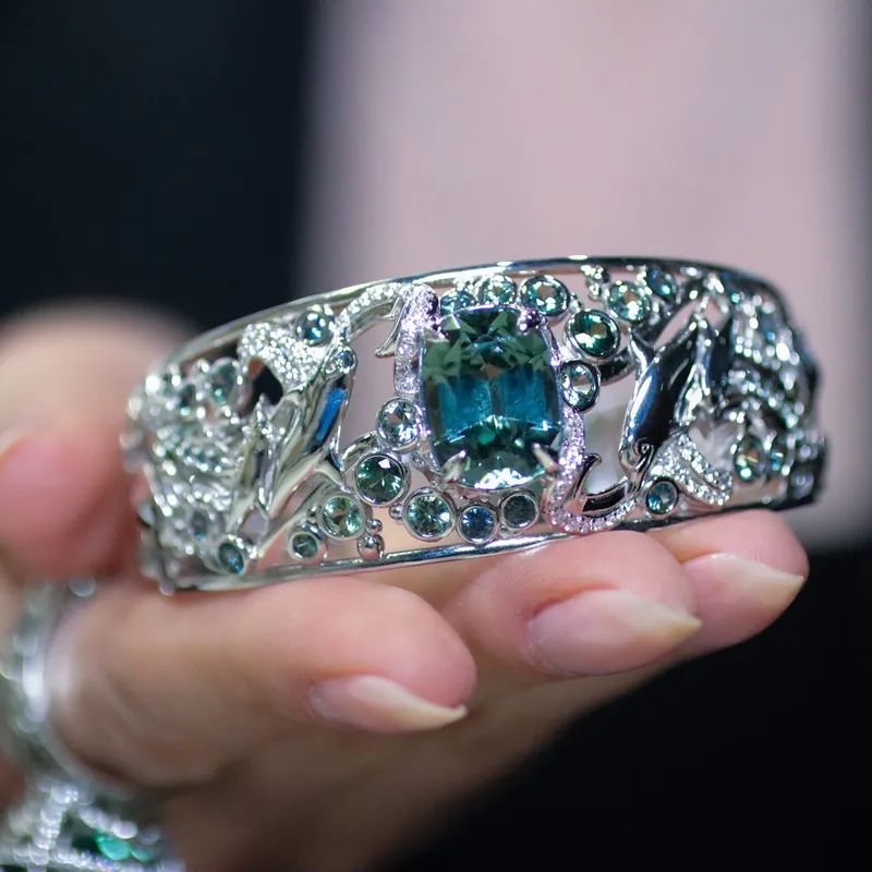 <p>The Exuma cuff bracelet, inspired by Caribbean waters, is set with an 11 carat cuprian tourmaline and accented with diamonds, blue-green sapphires, and marine animals in white gold</p>