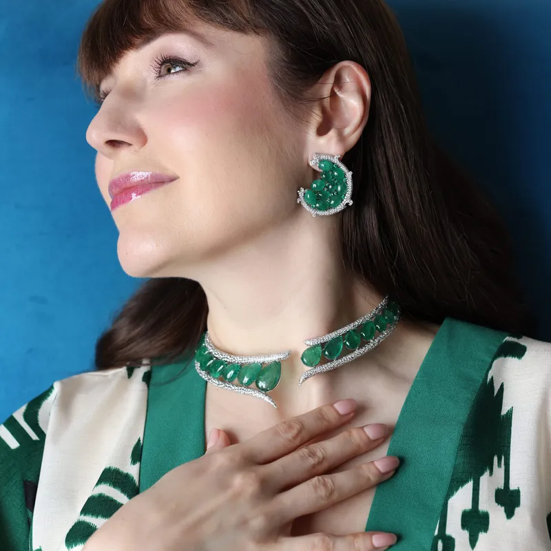 <p>Katerina Perez wears the Halo Spiral earrings and the Stellar Emerald collar necklace by Renu Oberoi, set with a combined 138.57 carats of emeralds and 17.11 carats of diamonds</p>

