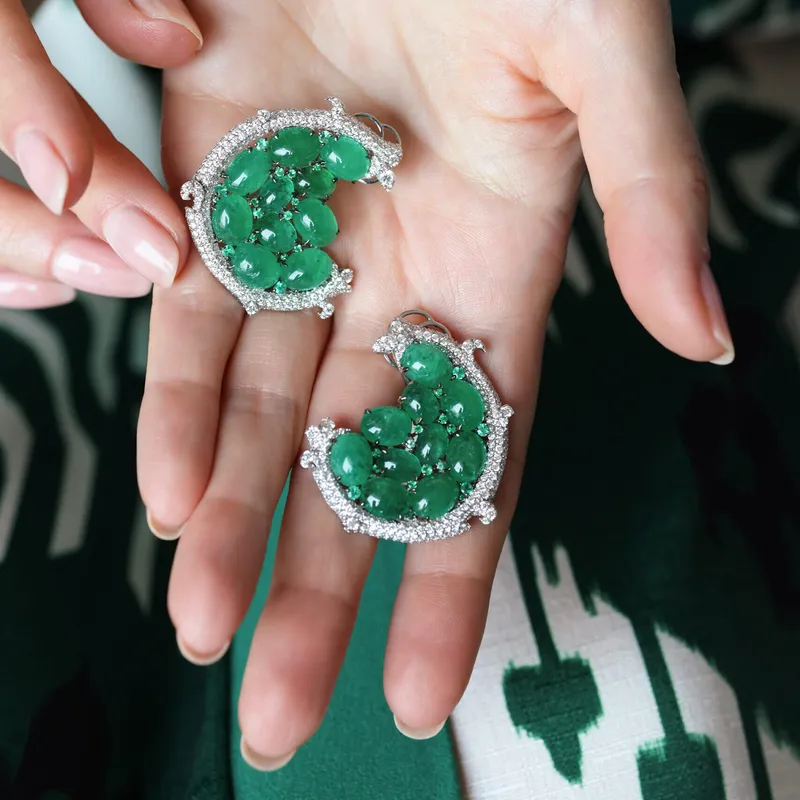 <p>The Halo Spiral earrings by Renu Oberoi with 4.61 carats of diamonds and 33.57 carats of emerald cabochons</p>
