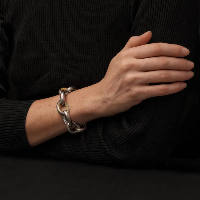 <p>Xio bracelet in 18K white gold, set with white, yellow and black diamonds</p>

