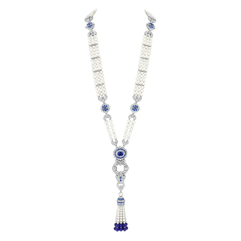 <p>Pompon Margaret long necklace watch features multiple strands of white pearls, accented with blue gemstones and diamonds</p>