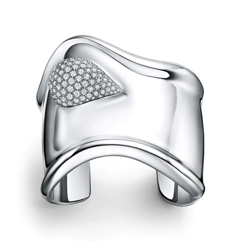 Tiffany & Co.’s sculptural Elsa Peretti Bone Cuff, accented with pavé diamonds and defined by its fluid, organic form.