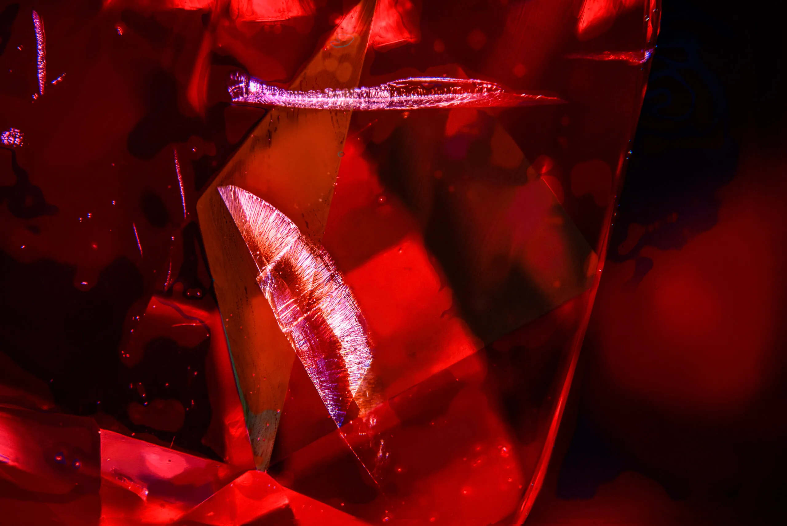 <p>The wing shaped microscopic feature inside the 22 carat cushion-shaped Tanzanian red spinel that inspired the House of Gübelin to create the Tanzanian Sunrise High Jewellery necklace </p>
