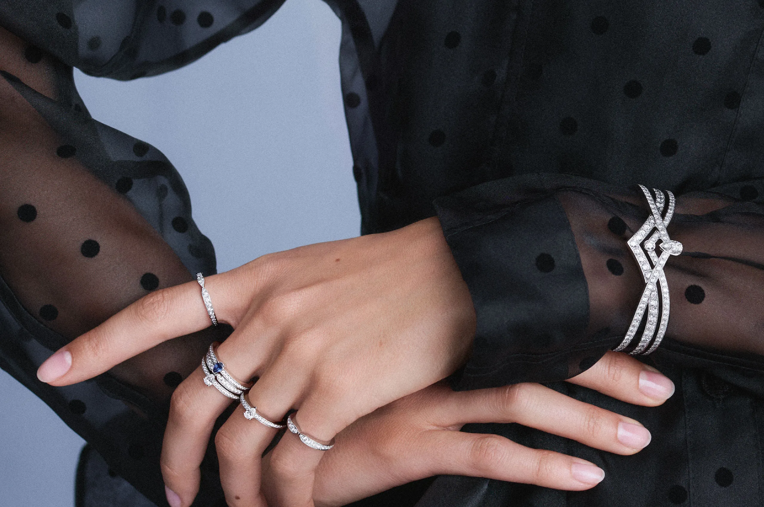 Joséphine High Jewellery parure by Chaumet, pairing an openwork diamond bracelet with coordinating rings, including the sapphire-set Triomphe de Chaumet design.