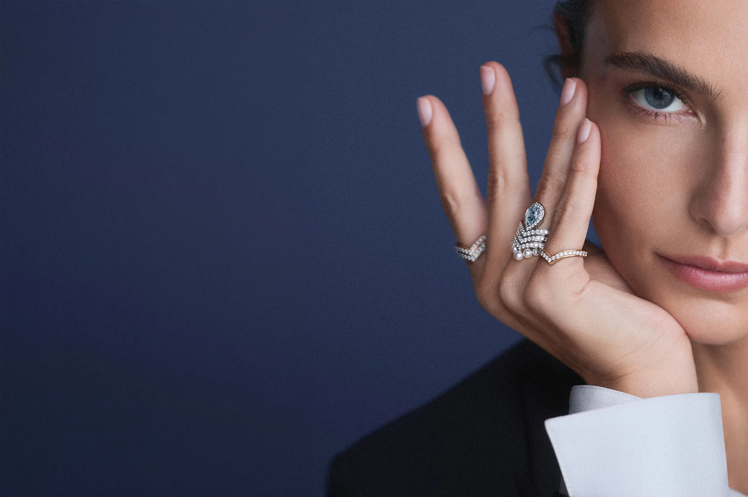 Joséphine ring in white gold, set with five Akoya pearls and brilliant-cut diamonds, alongside various rings from the collection showcasing the beauty of stacking.