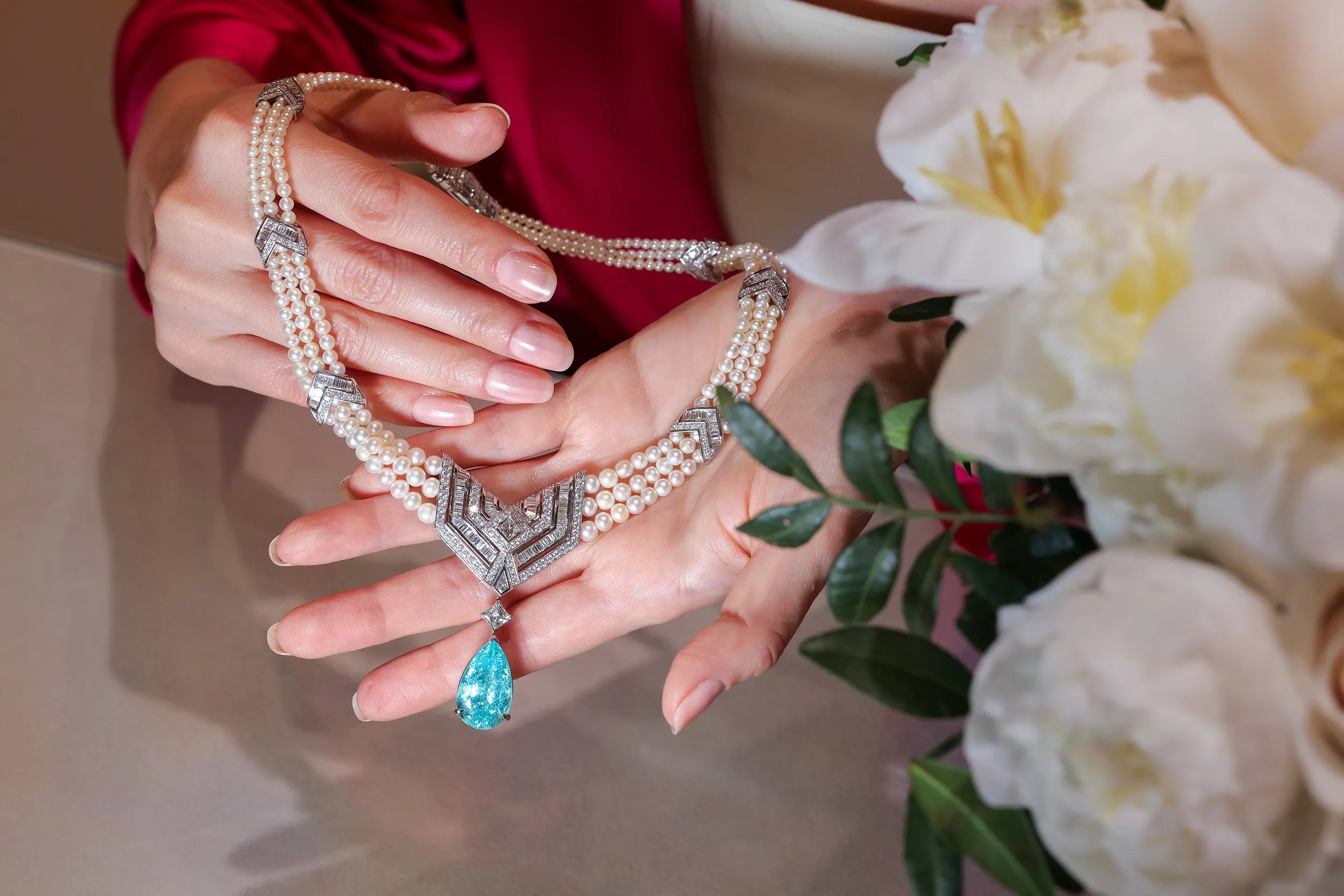 <p>Fusing the bold spirit of Art Deco and the geometric grace of Arabian architecture, this Al Zain Arab Deco high jewellery necklace is set with a rare pear shape Paraiba tourmaline drop</p>
