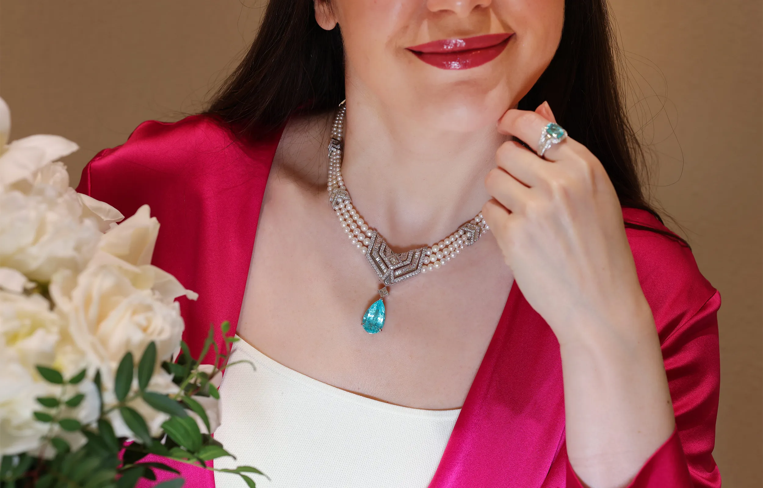 <p>Katerina wears Al Zain’s Paraiba tourmaline, natural pearl and diamond Arab Deco high jewellery necklace in 18k white gold</p>