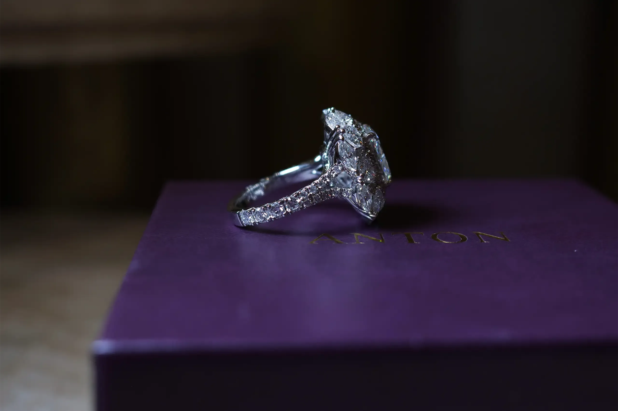 A side view reveals how the heart, marquise and round diamonds are arranged around the centre stone
